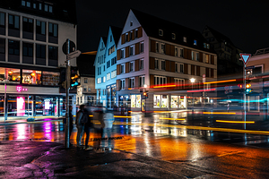 Night shot of blurred car lights and people on the main street in Tübingen