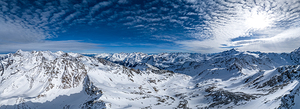 High res aerial panorama shot of scenic snowy mountain range in winter in the European Alps
