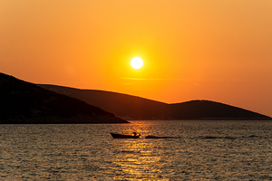 Small boat in the beautiful bay of Osor on the island of Cres-Losinj in the Adriatic Sea in Croatia during sunset