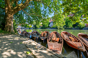 Historic punt boats Stocherkahn at a pier at the Neckar River in Tübingen Germany