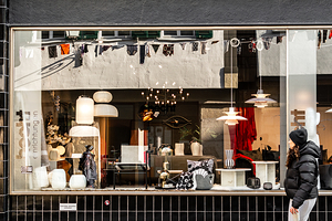 Street photo of reflections in a stylish furniture shop window in the city