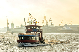 Harbor ferry on the Elbe River in Hamburg Germany at sunrise