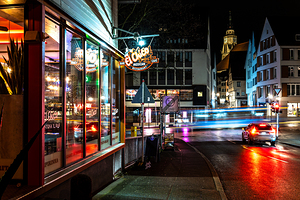 Night shot of restaurant and blurred car lights on a main street in Tübingen
