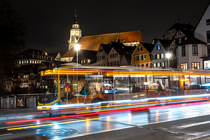 Night shot of blurred bus lights on a main street in Tübingen