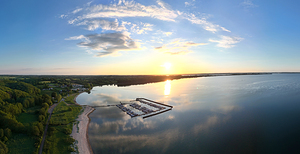 Aerial panorama shot of a beautiful sunset over the Baltic Sea at the marina of Bockholmwik in North Germany