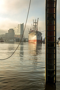 Cap San Diego and Elbphilharmonie at St. Pauli Landungsbrücken pier at the Elbe River in Hamburg Germany