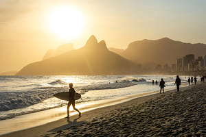 Surfer at Ipanema Beach in Rio de Janeiro in Brazil at sundown