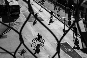 Black and white street photo of bicycles on a road in the city 