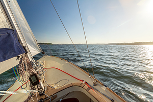 View from a sailing yacht sailing on the Baltic Sea during beautiful sunset 