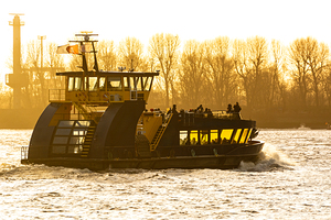 Closeup shot of ferry on the Elbe River in Hamburg during golden sunset 