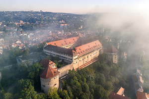 Close aerial view of the historic castle of Hohentübingen in the city of Tübingen in the morning fog