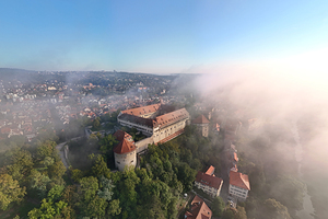 Aerial view of the historic castle of Hohentübingen in the city of Tübingen in the morning fog