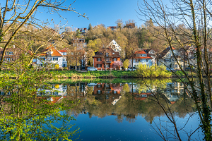 Historic houses reflecting in the Neckar River on a sunny day in spring in Tübingen 
