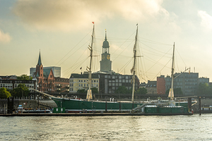 Skyline of Hamburg with famous Michel Church and historic sailing boat