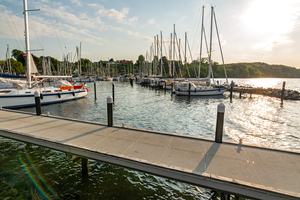 Sailing boats and pier in a marina Langballigau during sunset at the Baltic Sea in Northern Germany