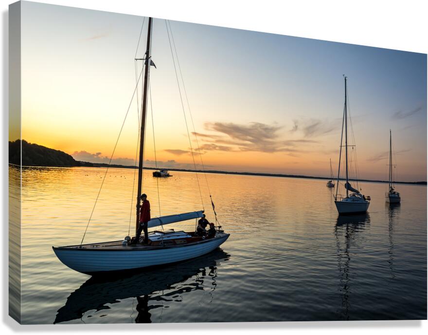 Sailing boats coming back into the harbour during scenic sunset at the Baltic Sea in Northern Germany Canvas Print