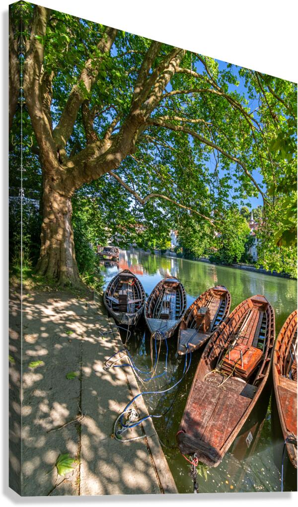 Traditional punt boats Stocherkahn at the pier at the Neckar River in Tübingen Germany Canvas Print