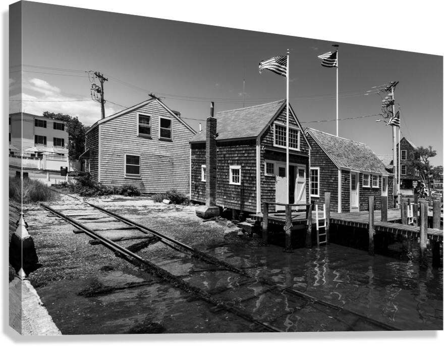 Black and white shot of historic harbour buildings and boat ramp on Cape Cod in New England  Canvas Print