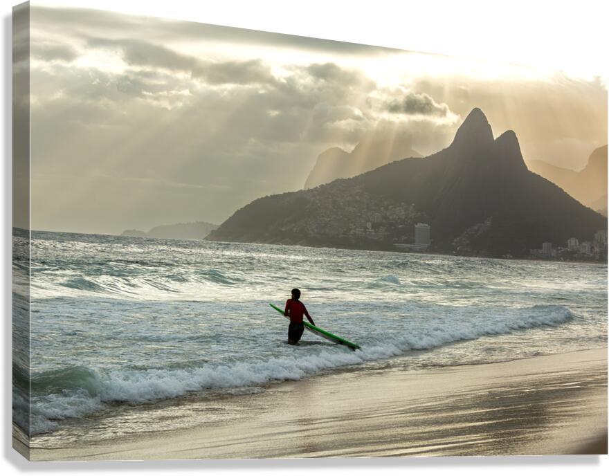 Surfer entering the water during dramatic sunset at Ipanema Beach in Rio de Janeiro  Canvas Print