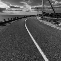 Black and white shot of coastal road on Cape Cod in New England 