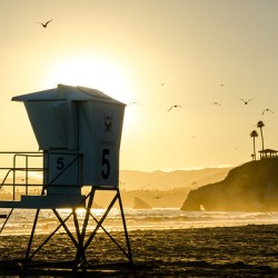 Stunning sunset behind a lifeguard post at Pismo Beach in California