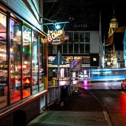 Night shot of restaurant and blurred car lights on a main street in Tübingen