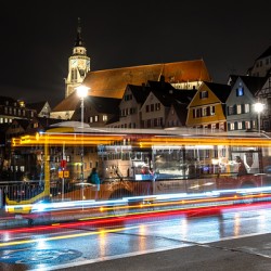 Night shot of blurred bus lights on a main street in Tübingen