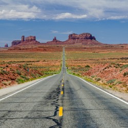 Road through the desert leading towards Monument Valley in the USA