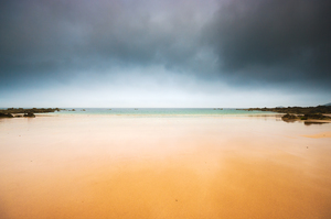 Empty beach and dark sky