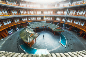 Man standing in Hakka traditional round house
