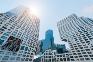 Modern buildings against blue sky and sun