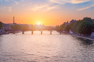 Paris skyline at sunset with river Seine in the foreground