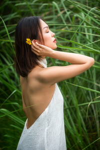 Young Chinese woman wearing a white dress in nature