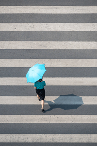 Young chinese woman with an umbrella walking jpg