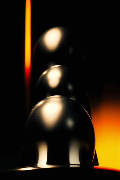 Abstract chrome decoration in a dark and orange light by Philippe Lejeanvre