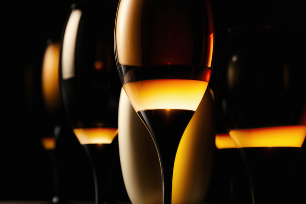Dark wine glasses in an orange light close up view by Philippe Lejeanvre