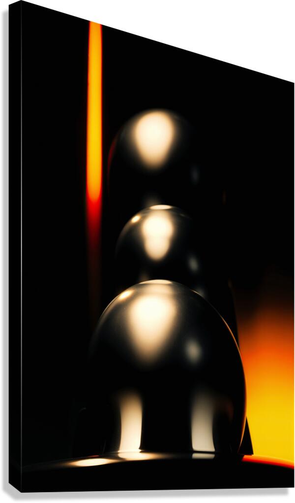 Abstract chrome decoration in a dark and orange light  Canvas Print