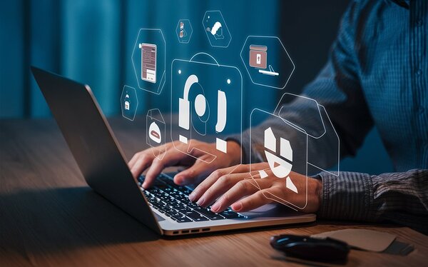 a person using a laptop at a table a stock photo Print