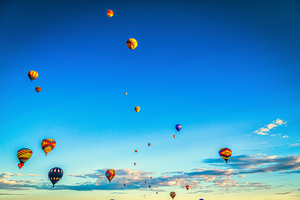 Colorful Hot Air Balloons Floating into Clear Blue Sky