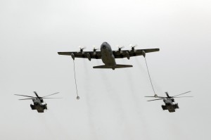 A MC-130W conducts an in-flight refueling for two MH-53J Pave Low III helicopters.