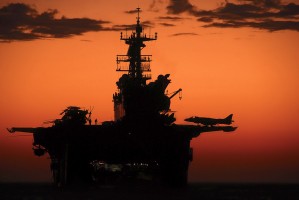 The setting sun silhouettes the amphibious assault ship USS Makin Island.
