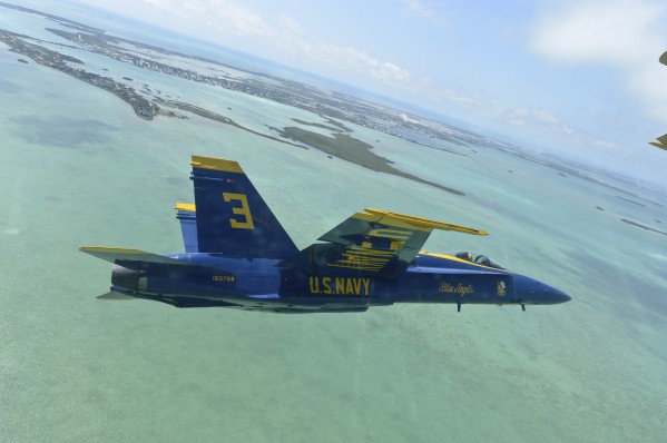 An F-A-18 Hornet of the Blue Angels flies over the Florida Keys. by StocktrekImages