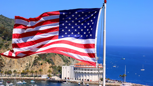 American star spangled flag waving in California. A large American flag is flying high above by Elijah Lovkoff