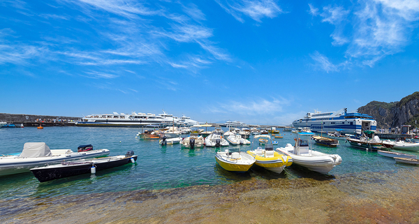 Italy scenic views of Capri Island Bay. Ships yachts and ferries in Capri harbor by Elijah Lovkoff