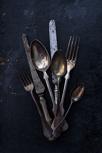 Vintage silverware on dark table