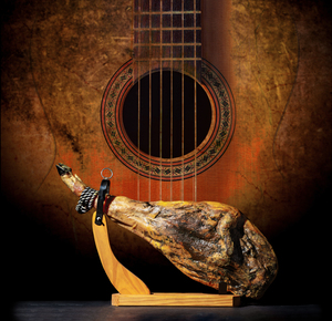 Dry Spanish ham Jamon Serrano Bellota Italian Prosciutto Crudo or Parma ham.Slicing Spanish iberic ham. Design Spanish jamon and spanish guitar traditional food and culture.