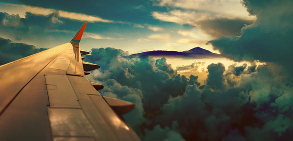 Sunrise and clouds.Flight and journey to destination.Concept of airplane travel. Flying above the city. Scenery sunset landscape. by Carlos Castilla