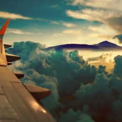 Sunrise and clouds.Flight and journey to destination.Concept of airplane travel. Flying above the city. Scenery sunset landscape.