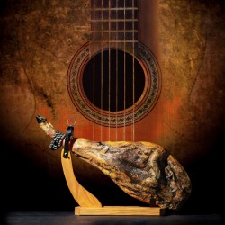 Dry Spanish ham Jamon Serrano Bellota Italian Prosciutto Crudo or Parma ham.Slicing Spanish iberic ham. Design Spanish jamon and spanish guitar traditional food and culture.