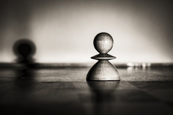A single white pawn on a chessboard. Monochrome by Jurica Tomic Svarun